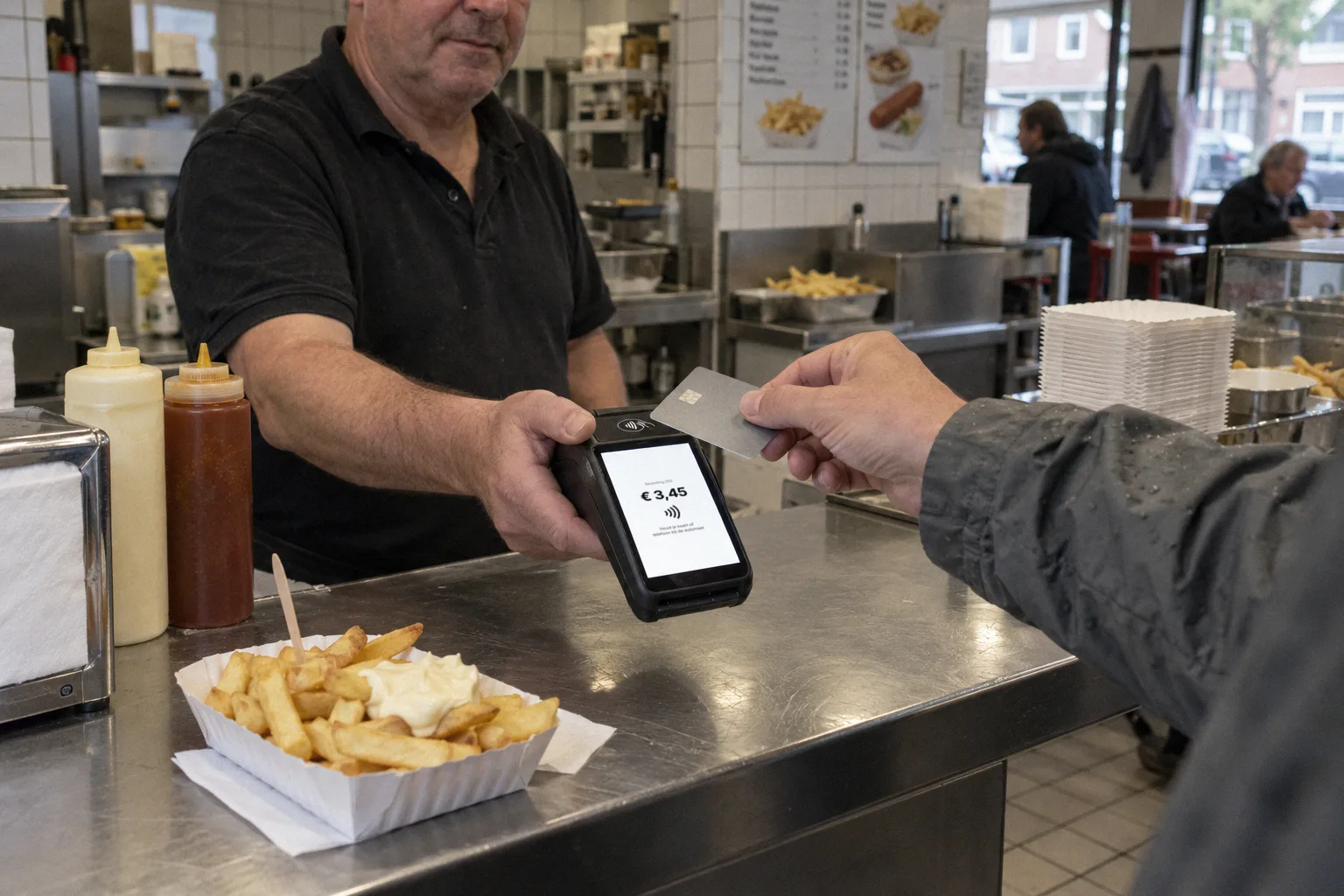 A customer pays contactless in a snack bar